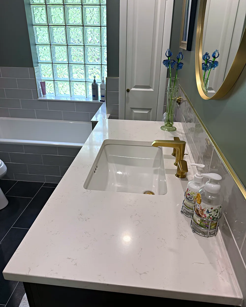 Bathroom vanity with gold fixtures, house cleaning in Denville, NJ
