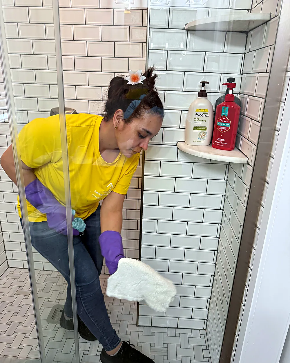 Cleaner scrubbing a tiled shower, house cleaning in Morris Plains, NJ