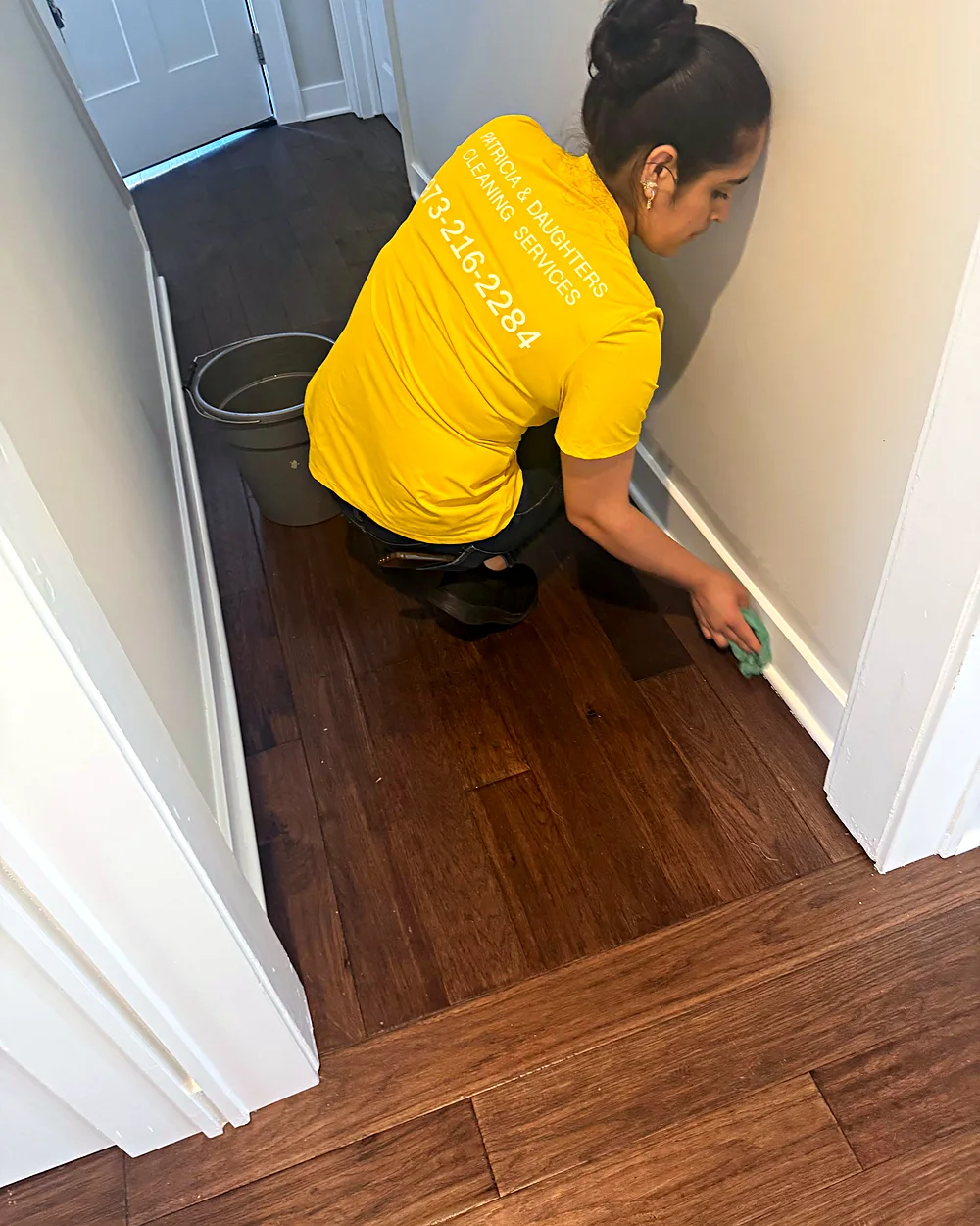 Cleaner wiping baseboards during a deep cleaning in Morristown, NJ