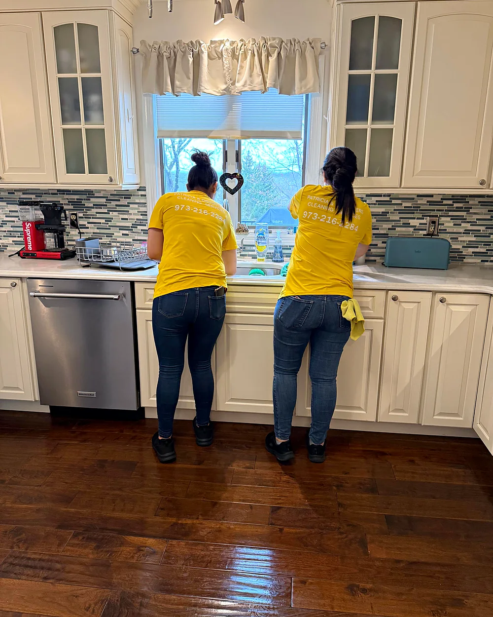 Two cleaners from Patricia and Daughters cleaning a kitchen in Morristown, NJ