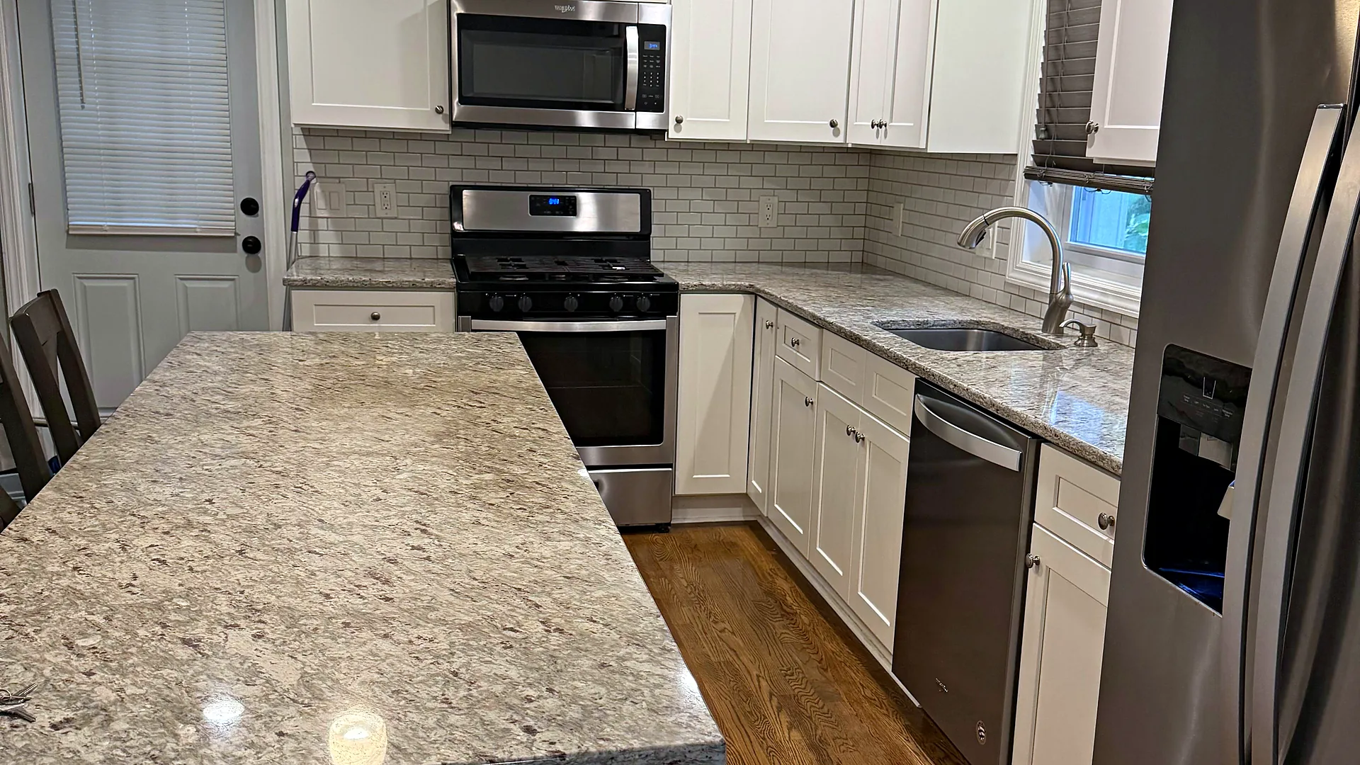 White kitchen with granite island, house cleaning in Mount Arlington, NJ